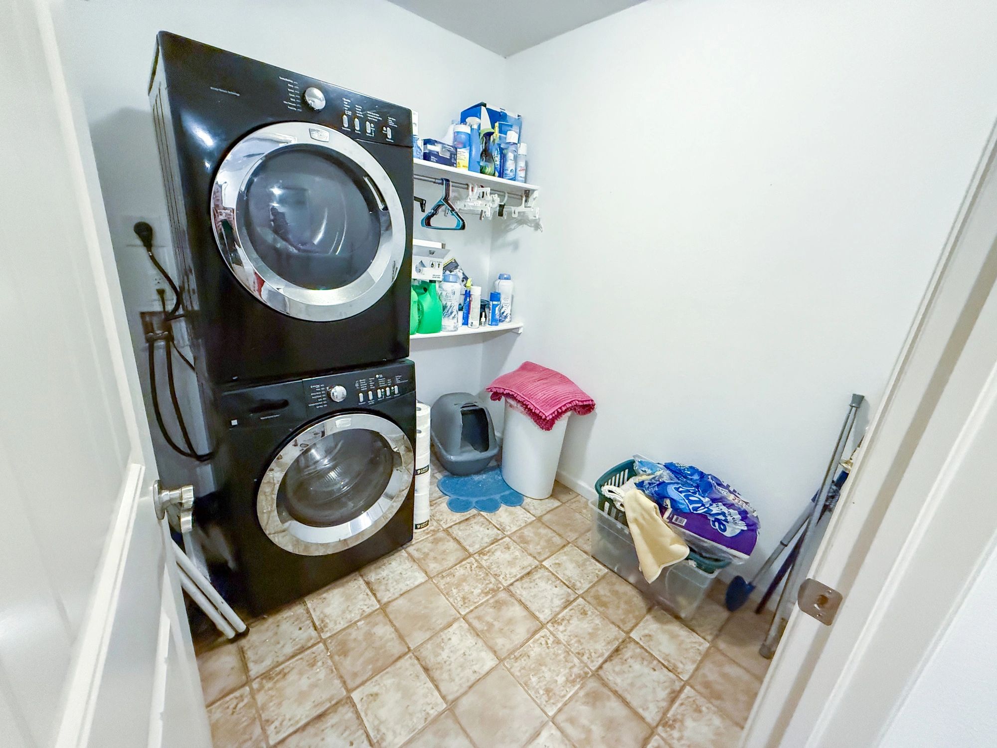 Organized utility room with cleaning and storage supplies